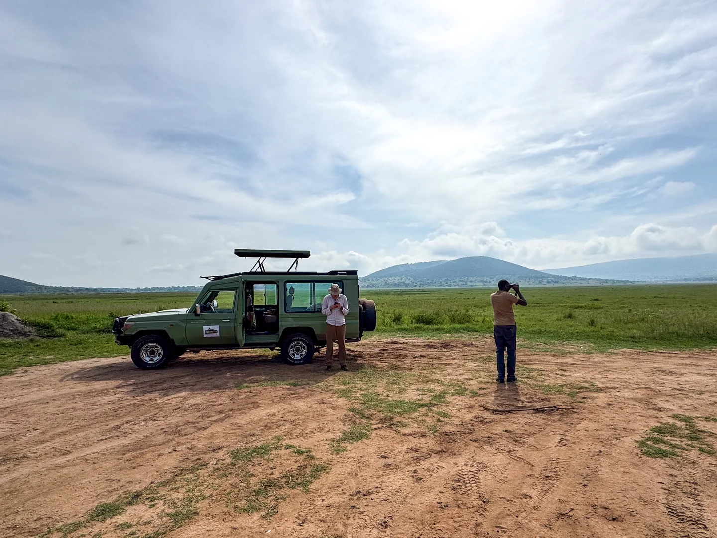 Rwanda Eco Company and Safaris safari vehicle and guide on the East African plains