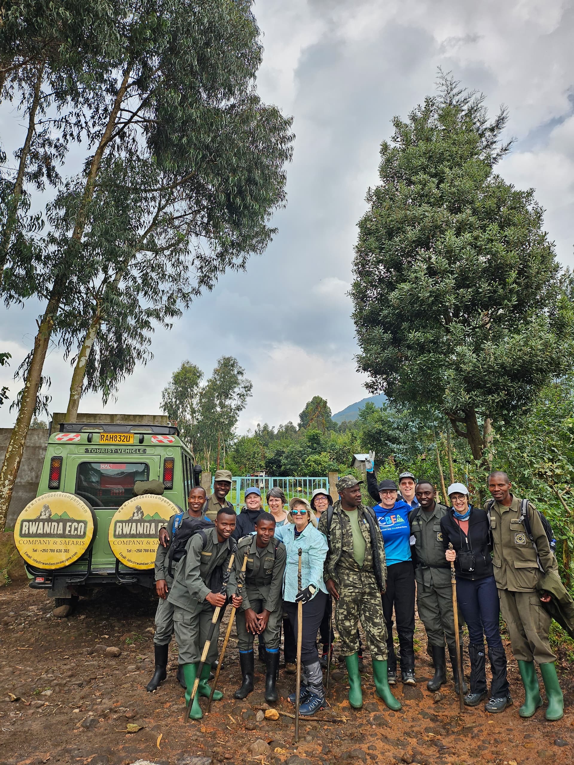 Réginal Hakizimana and the Rwanda Eco Company and Safaris team with their branded safari vehicle at Volcanoes National Park, Rwanda